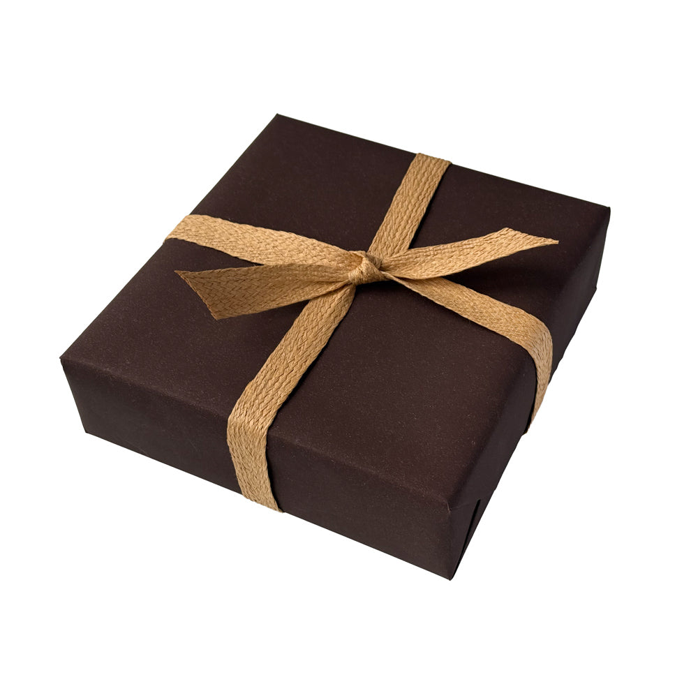 Box wrapped in chocolate brown wrapping a natural paper ribbon